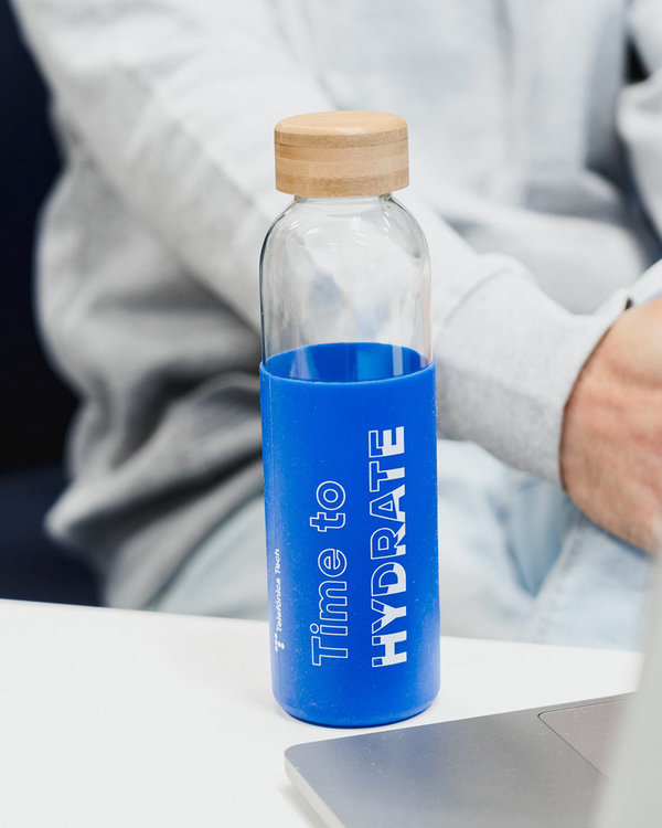 Glass bottle with blue sleeve